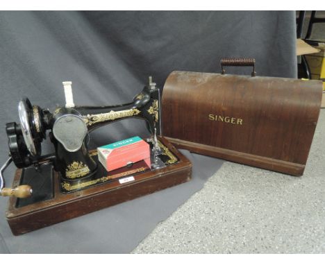 A vintage hand cranked singer sewing machine serial EC608503