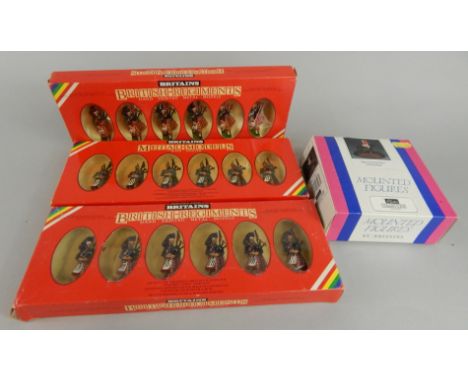 Various Britains British Regiments metal model figures, comprising 7406 Black Watch pipers, another set similar and 72416 Sco