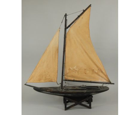 A late 20thC pond Yacht or model, with single mast, on an 'x' shaped stand stand