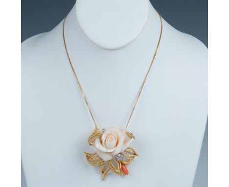 The delicately carved rose is made from coral and set in 18k gold with seven small round diamond accent stones. It has two ba