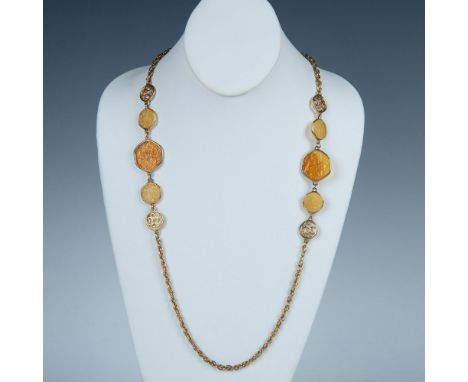 This necklace has a gold tone chain divided by two sections of decorative cream and honey colored lucite. Sarah Coventry tag 