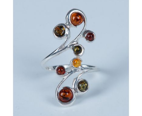 Gorgeous ring with round amber stones set in sterling silver. Stamped 925 inside the band. Size 7.25, but it can be adjusted.
