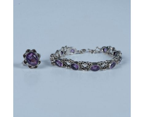 Oval amethyst stones set in highly decorated sterling silver. The bracelet is stamped 925 on the clasp and measures 8.25"L en