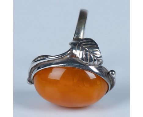 This unique ring has a rich Baltic amber stone set in sterling silver with delicate leaf decorations. It is stamped Poland an