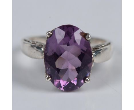 Made in New Mexico, this ring is made from finely detailed sterling silver set with a stunning oval amethyst stone. The band 