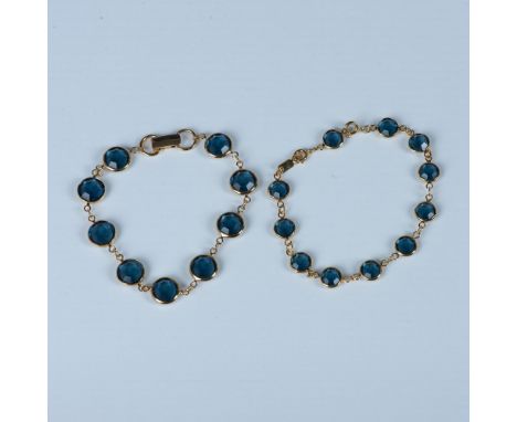 The bracelet with the larger links has a fold-over clasp and measures approximately 8.25"L. The second bracelet has a spring 