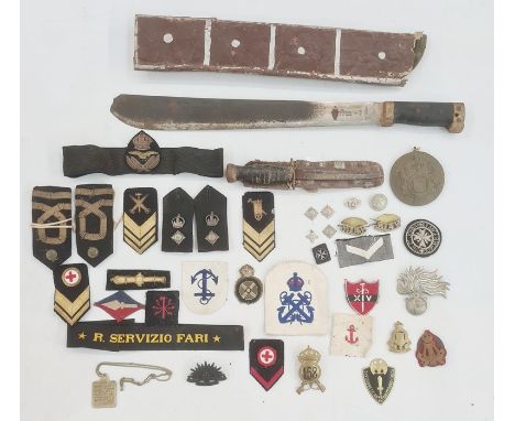 Collection of British cap badges, naval badges and rank markings, one box and a WWII machete&nbsp;