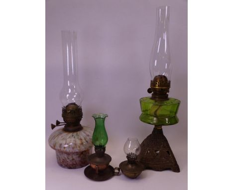VINTAGE OIL LAMPS (4) including a mottled glass font example, another with green glass font on a cast iron base and two small