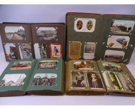 VINTAGE POSTCARDS approximately 1200 contained in four albums, mainly UK, including Seaside, Transport, Busy Market and Stree