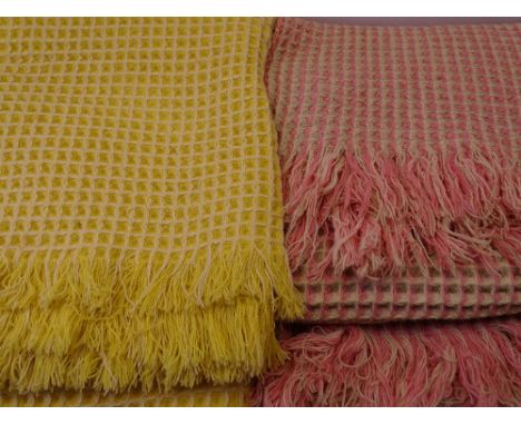 TWO VINTAGE WOOLLEN WAFFLE BLANKETS, one Pink 220 x 152cms, one Yellow 220 x 212cms