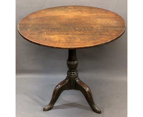 ANTIQUE OAK TILT-TOP TRIPOD TABLE having a 76cms diameter top on a turned column base and three feet, 70cms H