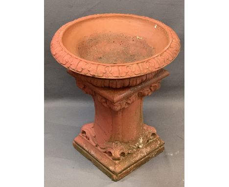 RECONSTITUTED STONE GARDEN PLANTER PAINTED RED having a dished top with acanthus leaf decoration, 55cms diameter on a short, 