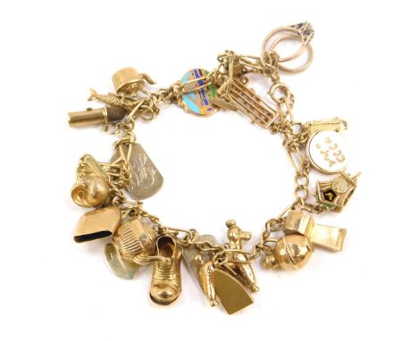 A 9ct gold oval and curb link charm bracelet, on a bolt ring clasp with safety chain and twenty five charms as fitted, two be