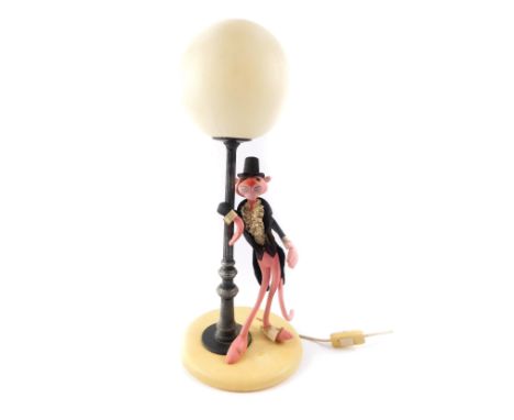 A Linea Zero Italian Pink Panther table lamp, modelled standing leaning against a lamp post, on a circular cream base, 52cm H