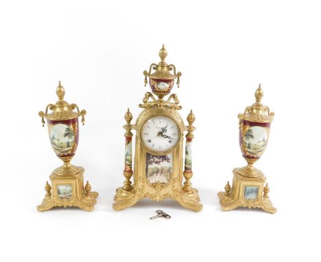 A 20thC German Imperial brass and porcelain clock garniture, the clock with white enamel dial bearing Roman numerals, eight d