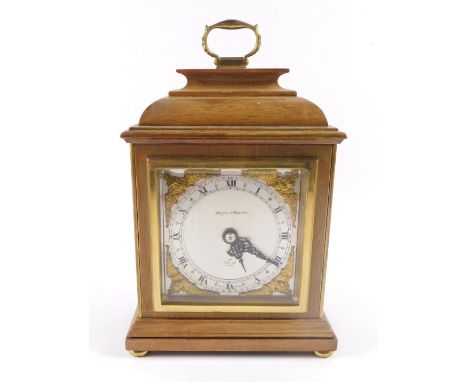 A 20thC Elliott mahogany cased mantel clock, for Mappin &amp; Webb Ltd, square silvered dials with gilt spandrels of cherubs 