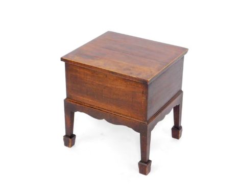 A George III mahogany and boxwood line inlaid box commode, with a hinged lid, raised on square tapering legs on spade feet, 4