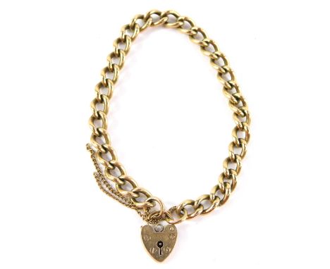 A 9ct gold curb link bracelet, on a heart shaped padlock clasp with safety chain as fitted, 26.0g.