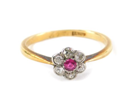 A ruby and diamond flower head ring, set in yellow metal stamped 18ct, size K, 1.9g.