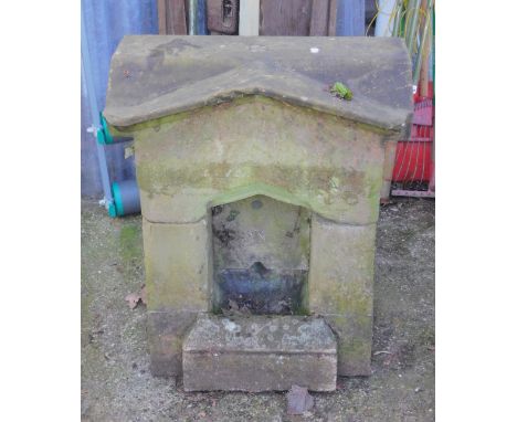 An early 20thC stone dog fountain drinking trough, of temple form, carved above the niche with '1912, In Remembrance of King 