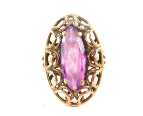 An amethyst solitaire ring, marquise cut in a yellow metal oval open work setting, and open work shank, size O, 8.4g.