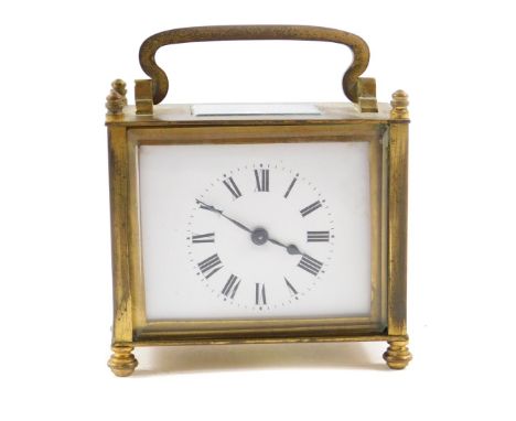 A French rectangular brass cased carriage clock, inset bevel glass, enamel dial bearing Roman numerals, the case of plain for