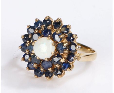 9 carat opal and sapphire set ring, the central opal with two rows of sapphires, 4.5 grams, ring size O