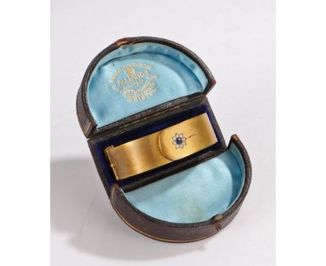 15 carat gold sapphire and pearl set bangle, the sapphire with a pearl surround forming a flower head to the wide brooch, 25 
