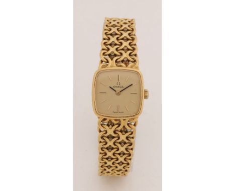 Omega 18 carat gold ladies wristwath, th signed gilt dial with baton markers, manual wound, the case 20mm wide, on an 18 cara