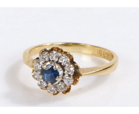 18 carat gold diamond and sapphire ring, the central sapphire with a cluster of diamonds surrounding, 3.1 grams, ring size K