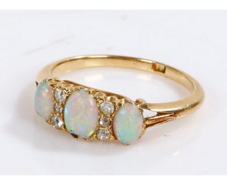 18 carat gold opal and diamond set ring, with three opals and six diamonds to the head, 2.9 grams, ring size M