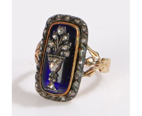 George III diamond and enamel Mourning ring, the centre of the ring with a diamond set urn on a blue enamel ground and a diam