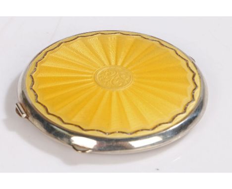 White metal and yellow enamel decorated powder compact, maker&nbsp;Joseph Gloster Ltd. of circular form with wavy yellow enam