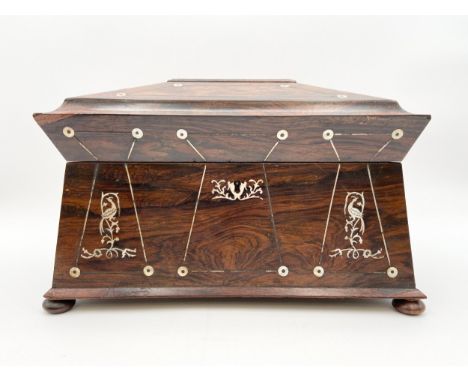 An early 19th century Regency rosewood tea caddy with mother of pearl inlay and a fitted interior, housing two inlaid caddy b