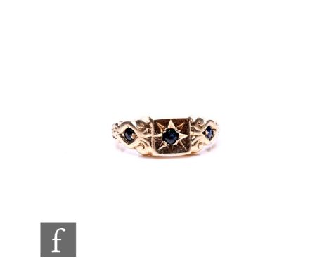 A modern 9ct hallmarked three stone sapphire ring, gypsy set stones to scrolled shoulders, weight 1.5g, ring size J 1/2.
