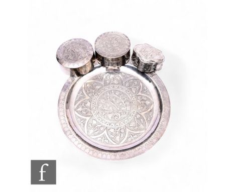 A small white metal circular card tray decorated with foliate detail, diameter 17.5cm, together with two matching circular tr