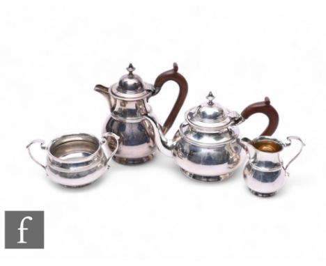 An early 20th Century four-piece tea service in the Georgian style, each piece with a ribbed body and raised to a plain foote