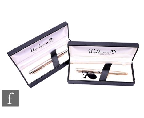 A Waldman sterling silver two-in-one ballpoint-pencil with twist action, engine turned, together with a Waldman white metal f