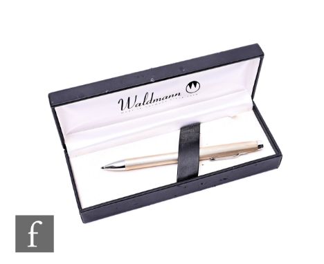 A Waldmann sterling silver two-in-one ballpoint pen with twist action alternating black and red points, engine turned and cas