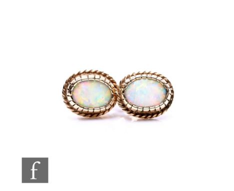 A pair of 9ct single stone opal stud earrings.