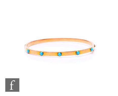 An early 20th Century 9ct hinged bangle detailed with five collar set turquoise stone to front, weight 6.8g, internal diamete