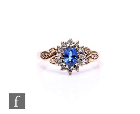 A 9ct hallmarked sapphire and diamond cluster ring, central sapphire within a diamond set border and shoulders, weight 3.3g, 