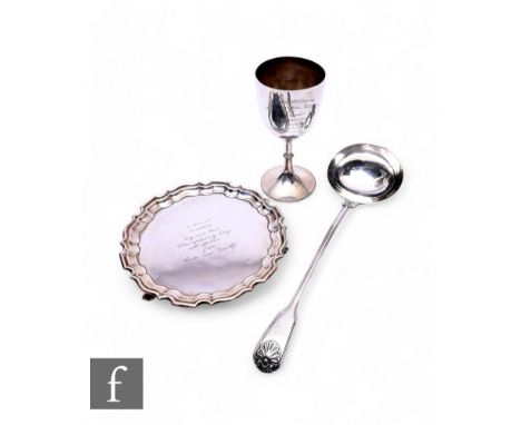 Three items of hallmarked silver a soup ladle, small salver and a goblet, total weight 25oz, various styles and dates. (3)
