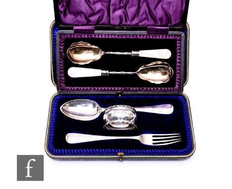 An Edwardian cased pair of silver preserve spoons of bamboo design with mother of pearl handles, Sheffield 1909 John &amp; Wi