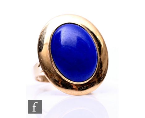 A 14ct single stone lapis lazuli ring, oval stone within wide gold border, weight 5.2g, ring size R.
