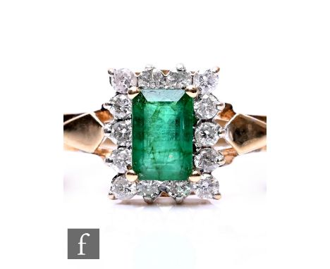 A 9ct hallmarked emerald and diamond cluster ring, emerald cut emerald to a diamond set border, weight 2.5g, ring size P.