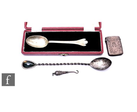 Four hallmarked silver items, two spoons, a vesta case and a glove button hook, total weight 83g, various styles and dates. (