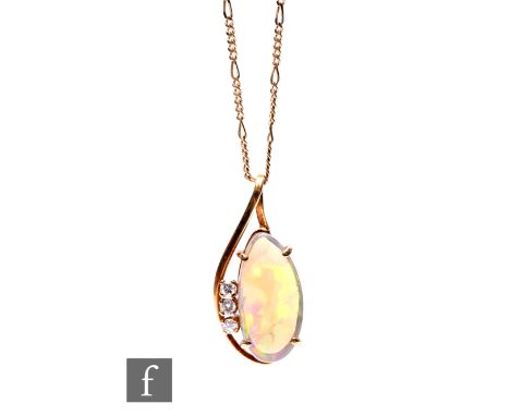 A 9ct opal and diamond pendant, oval claw set opal with three diamonds, length 25mm, suspended from a 9ct trace chain, total 