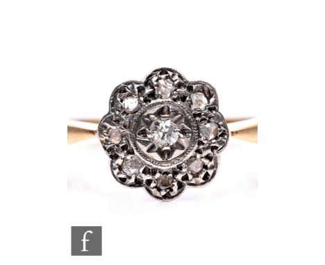 A mid 20th Century 18ct diamond daisy cluster ring, nine illusion set stones to knife edged shoulders, weight 3.5g, ring size