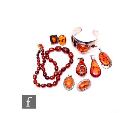A small parcel lot of assorted silver and white metal Baltic amber jewellery to include a bangle, beads, rings, pendants etc.